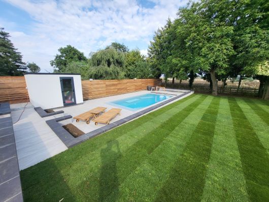 side view of the pool across the lawn