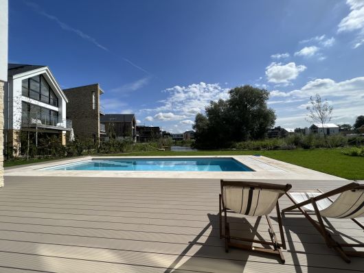 Outdoor pool during the day with cover open