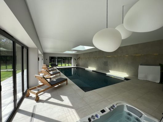 inside pool with jacuzzi and sunloungers