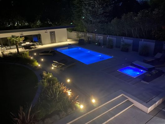 Pool and jacuzzi at night with led lights on
